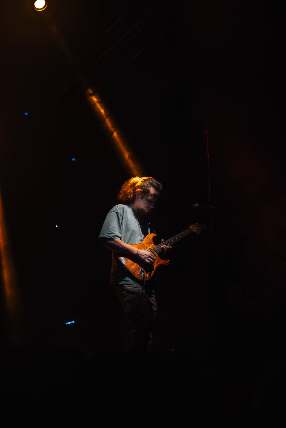 Bassist between blue light columns